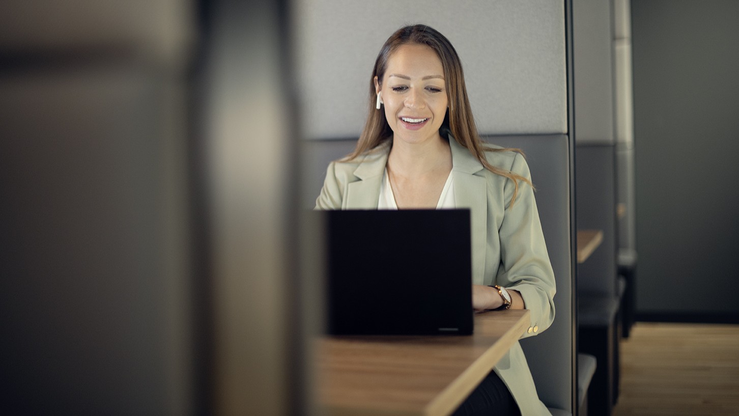 Woman with airpods in front of laptop