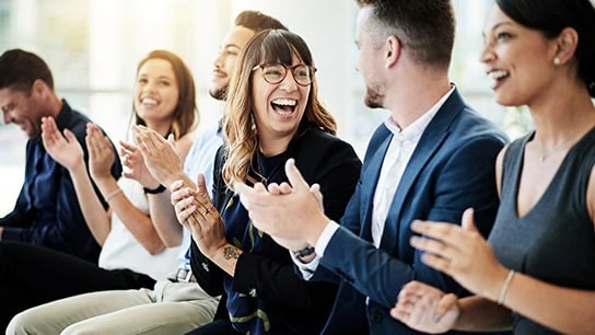 Colleagues clapping with a cheerful expression