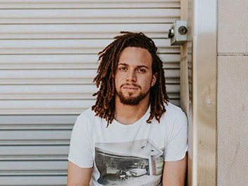 Confident man looking directly at the camera with a relaxed and assured expression