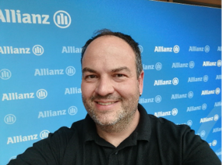Man in front of Allianz Logos
