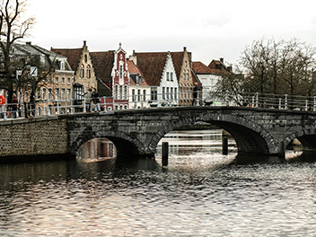 Stone bridge over a canal in Bruges, Belgium.