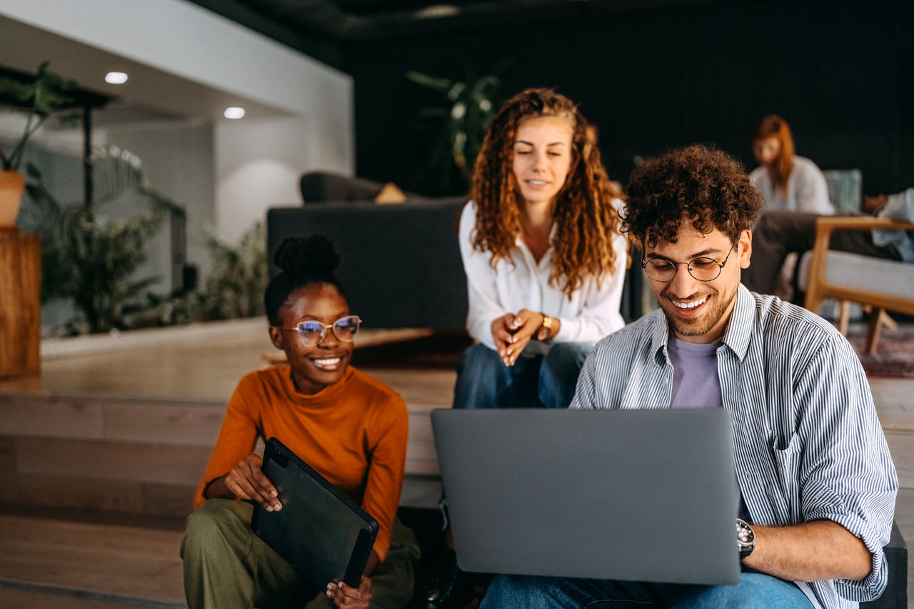 Graduates working on a laptop