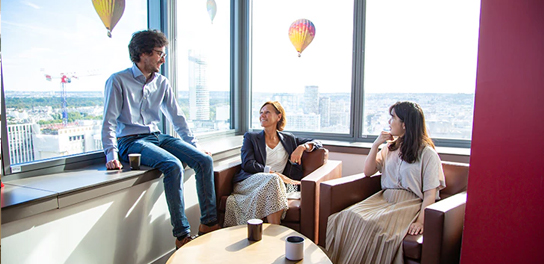 Trois collègues engagés dans une conversation joyeuse