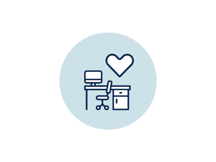A heart icon displayed on a desk, accompanied by a computer and a chair