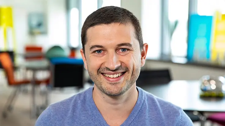 Allianz France employee in workspace smiling in camera