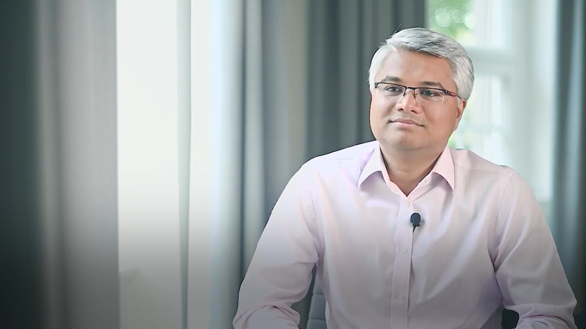 Head shot of an Allianz employee smiling at camera