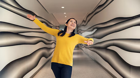 A joyful colleague in a corporate office hallway