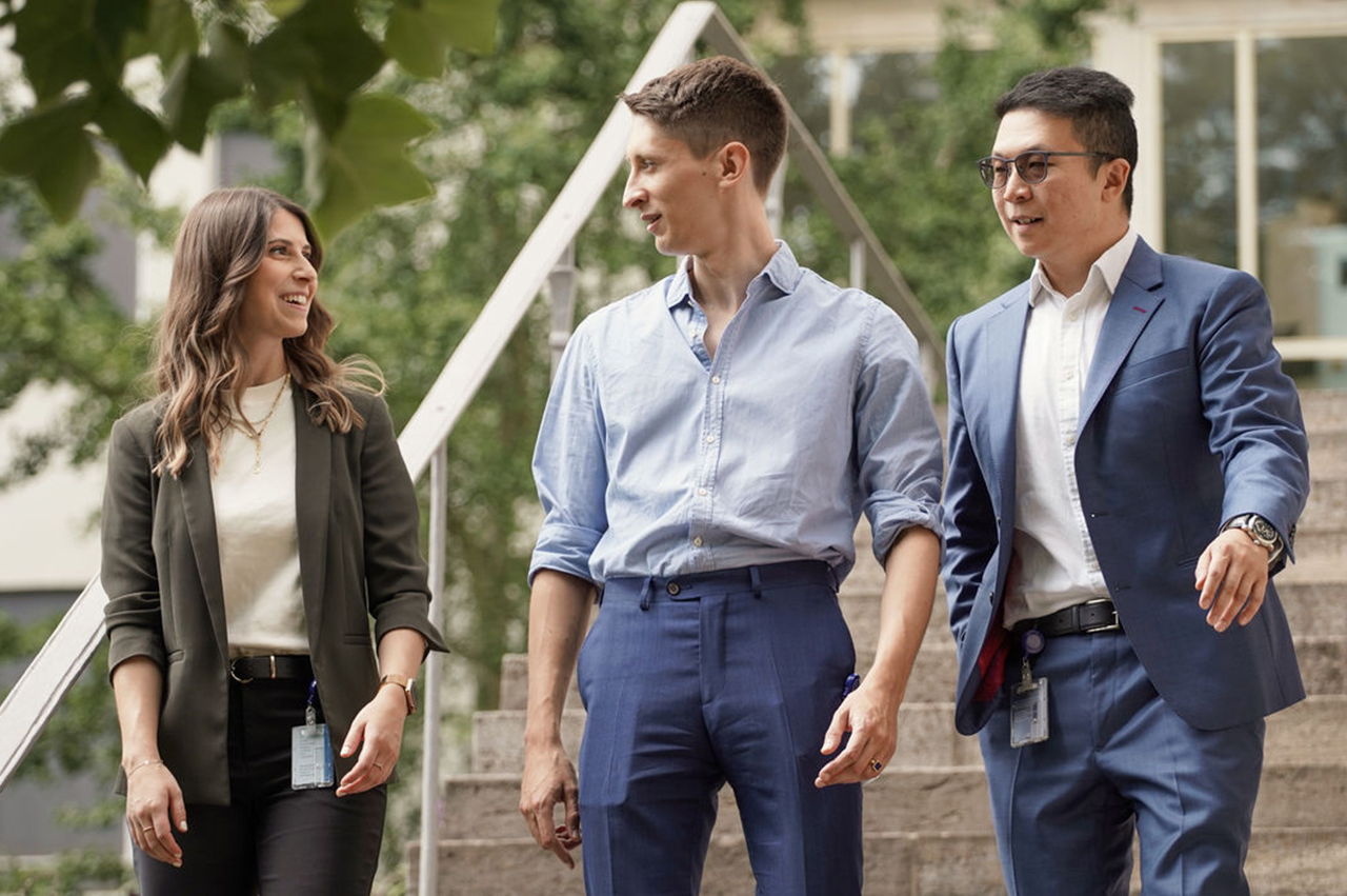 Three Allianz colleagues in a joyful conversation while walking
