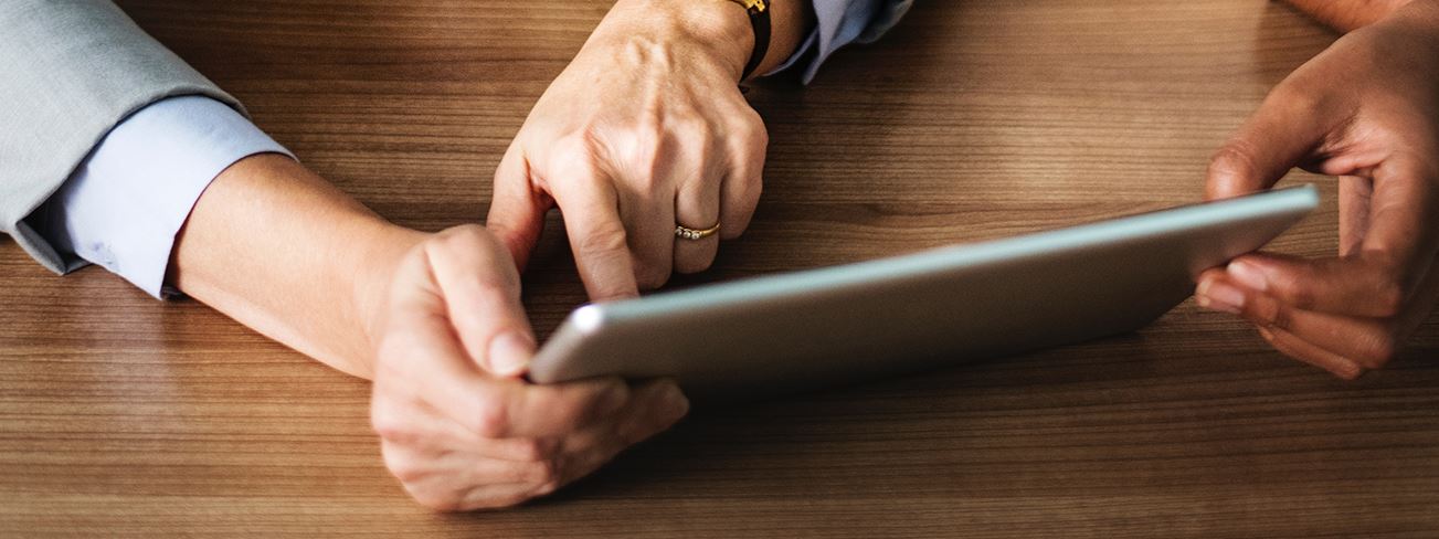 Close shot of a tablet operating by employees