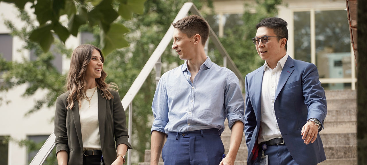 Allianz colleagues in a joyful conversation while walking