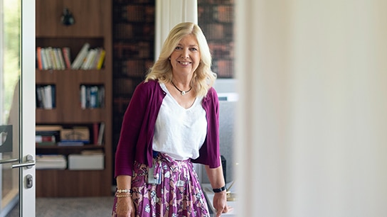 Senior woman employee smiling at the camera