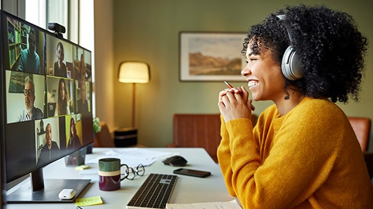 Happy young cheerful lady attending a virtual meeting