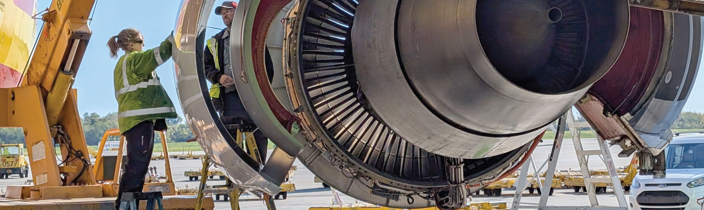 Line maintenance workers looking at engine