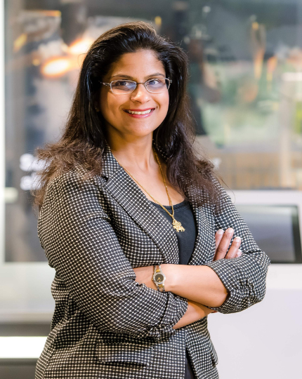Neeta, a program director, stands in for a headshot in BAE Systems Nashua location
