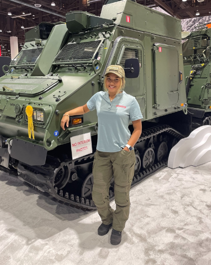 Sofia, a test and verification engineer smiles for a photo in front of a Bvs10.