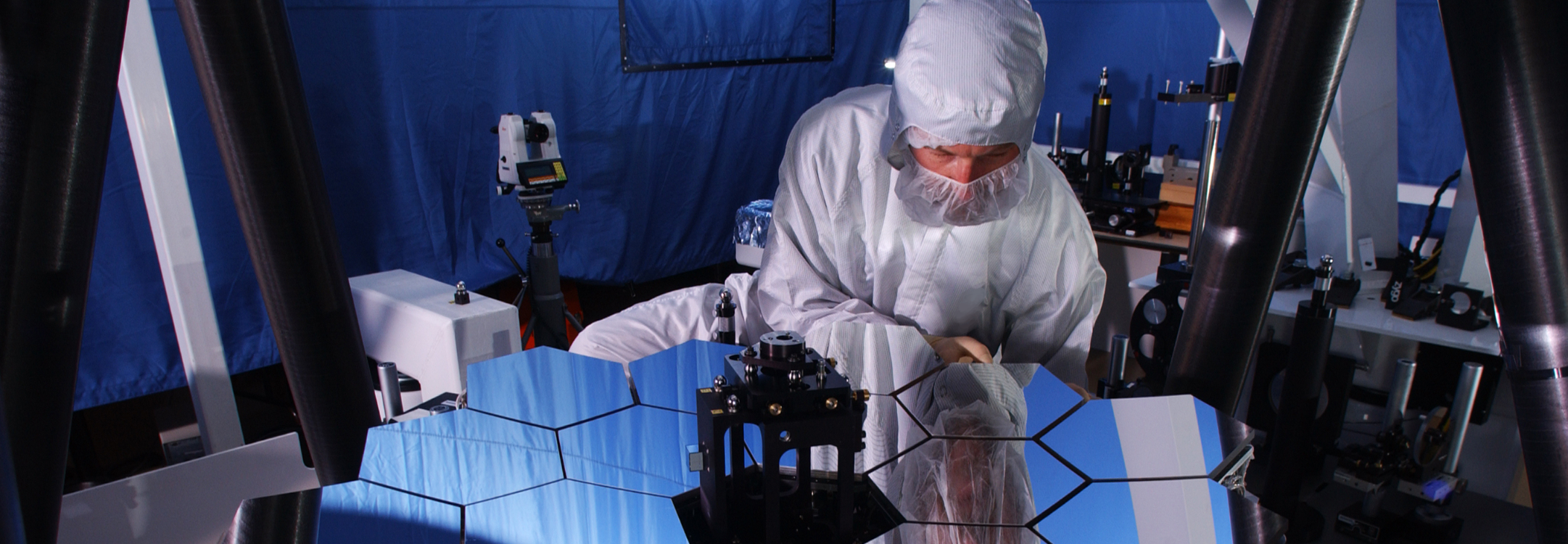 An engineer for the Space & Mission Systems team works on test mirrors for the James Webb Space Telescope.