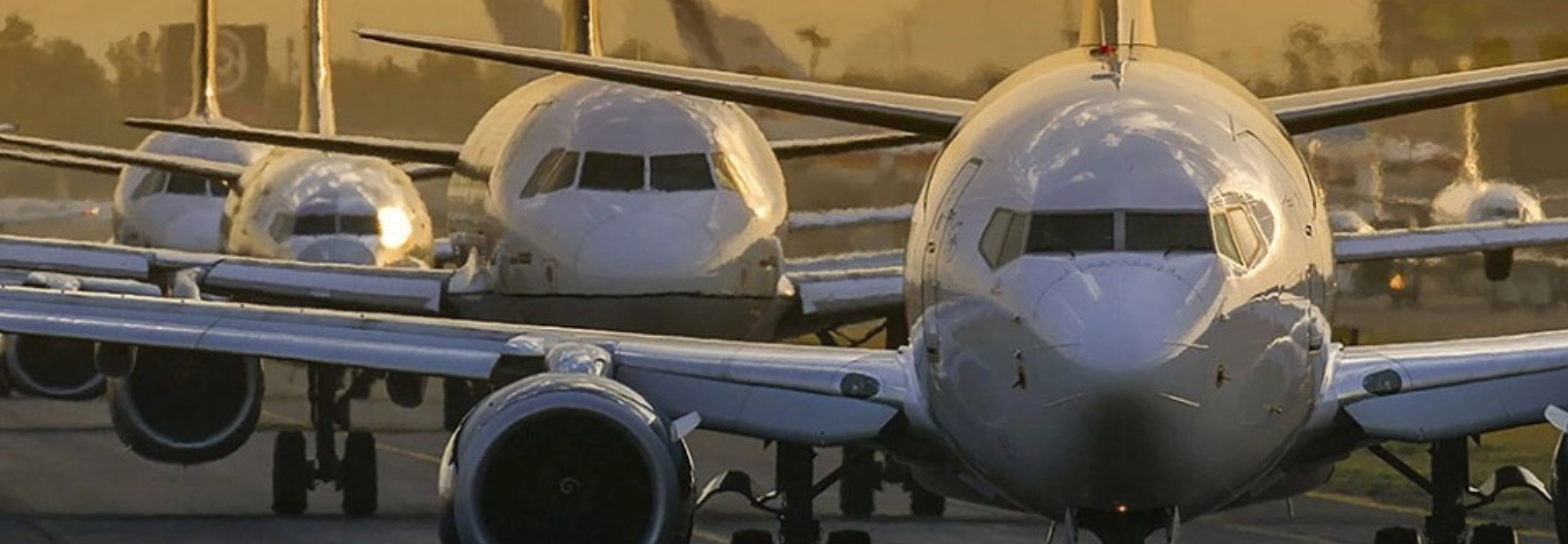 Commercial airplanes in a line.
