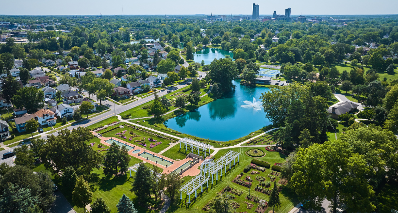 Aerial Lakeside Park gardens and fountains with distant downtown Fort Wayne.