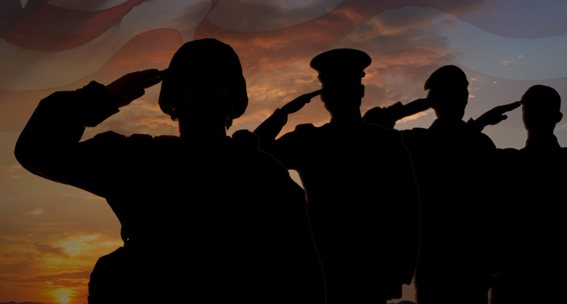 Four silhouette service members salute.