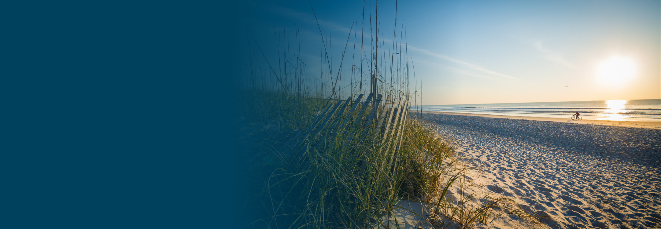 Someone riding a bike on a beach in Jacksonville, FL.