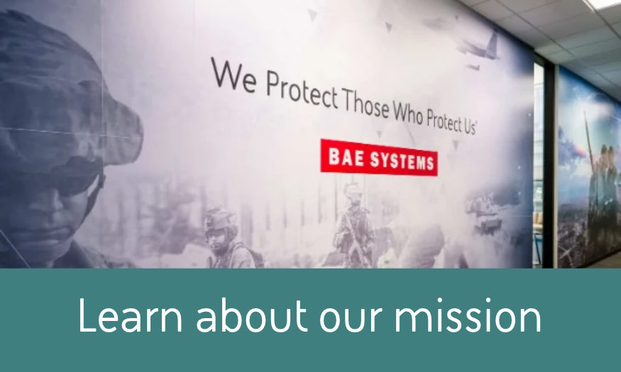 BAE Systems wall display featuring military imagery and the message “We Protect Those Who Protect Us,” representing the company’s mission.