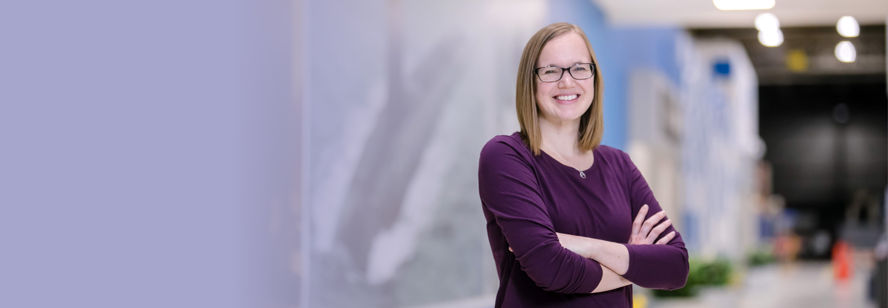 Melanie, a program manager out of Minneapolis, stands for a photo in a manufacturing facility.