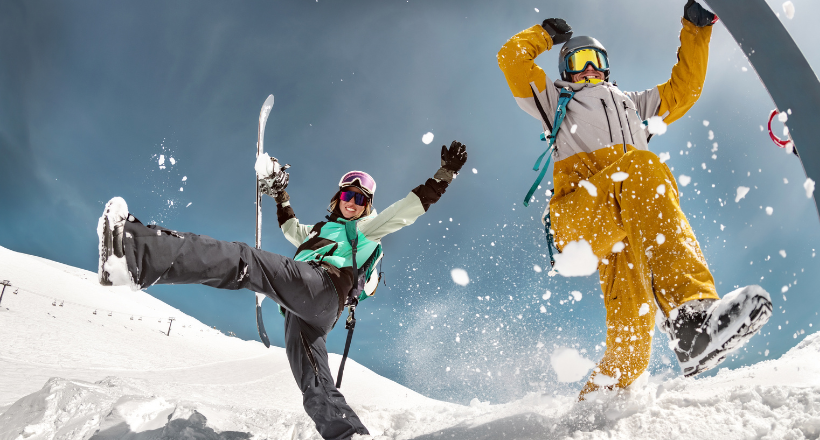 Two people taking a photo while snowboarding.
