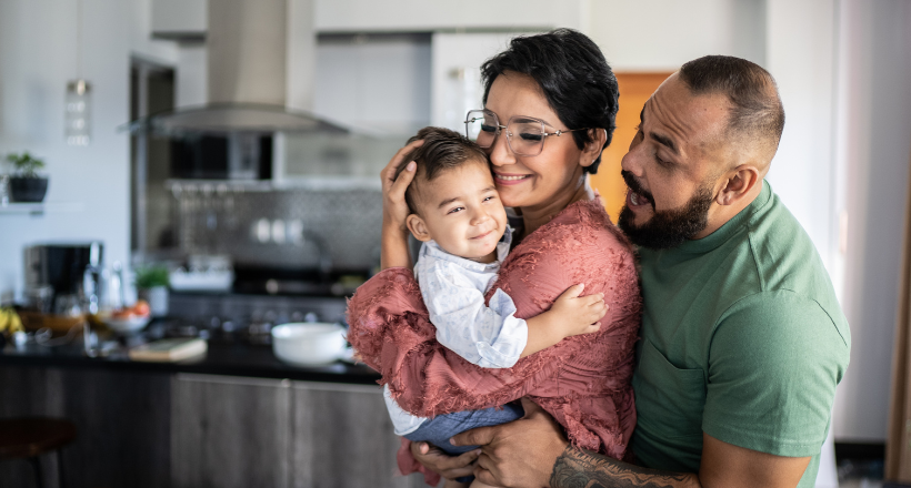 Stock photo of a family hanging out in the kitchen.
