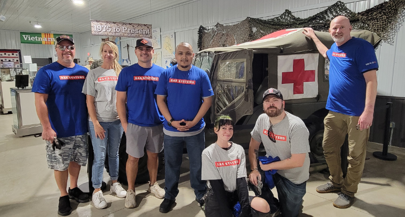 BAE Systems take a group photo after volunteering at the Veterans National Memorial Shrine and Museum.