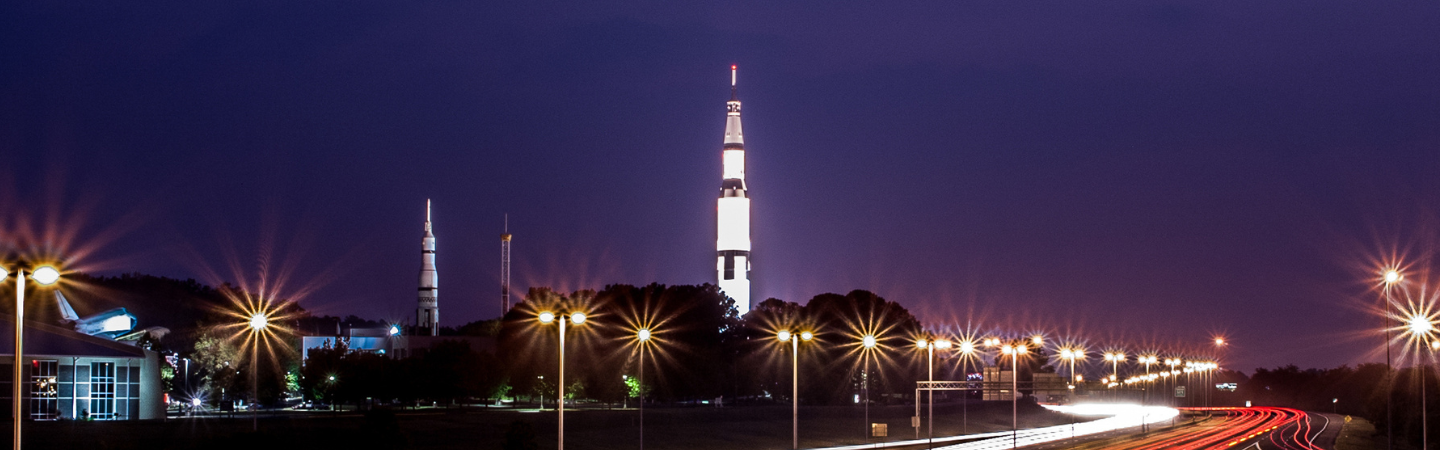 Interstate Traffic blurs by the Saturn 5 rocket on display at the Space and Rocket Center