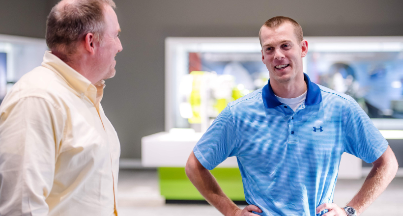 Nick, a Systems engineer, speaks with a colleague.