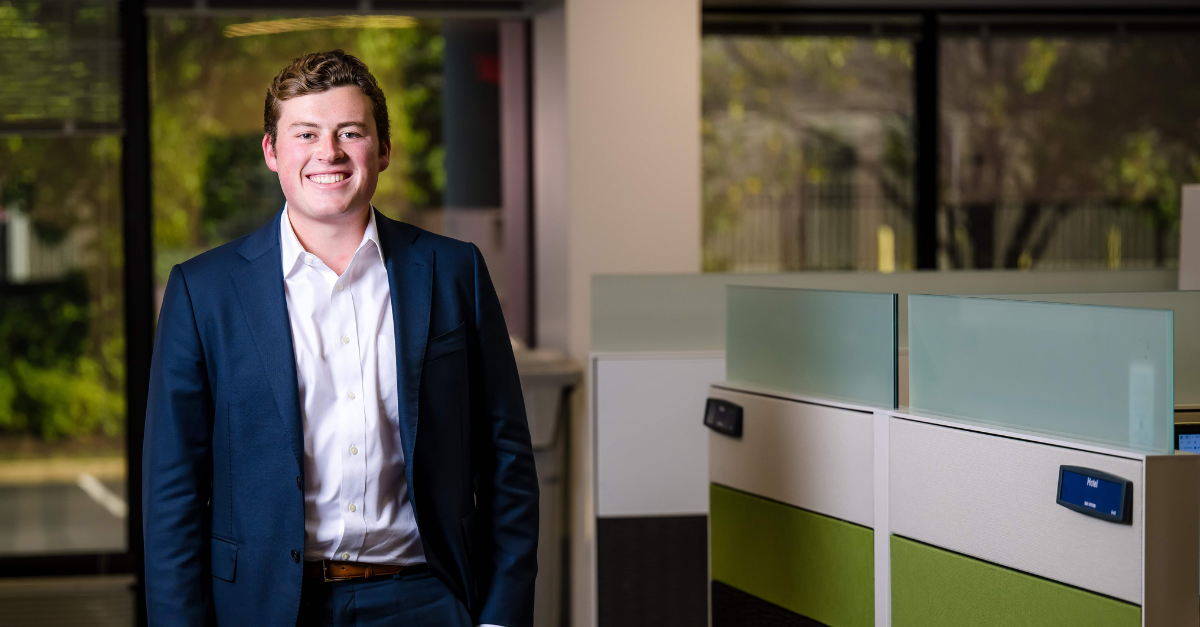 A man in a suit, featured in a BAE Systems career success story about internships turning into a full-time job.