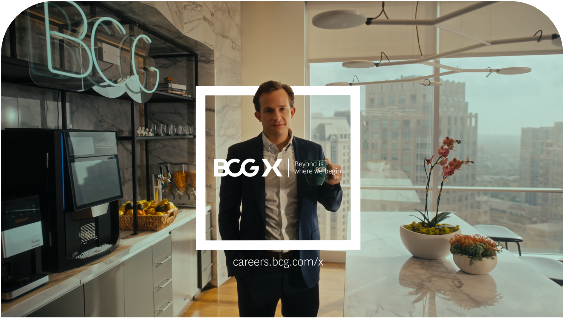 Jordan holding a coffee cup in an office