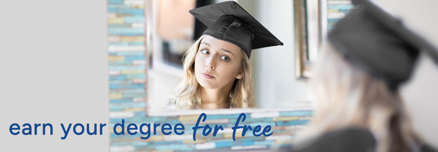 Person wearing a graduation cap looking into a mirror, with the reflection also showing the cap.