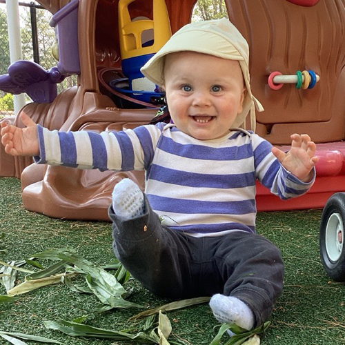 Cute infant outside playing 