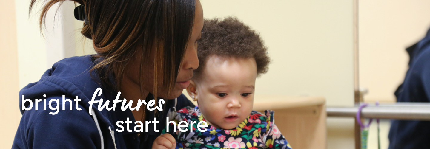 Adult and child sitting together in a warm, nurturing indoor setting with the phrase "bright futures start here."