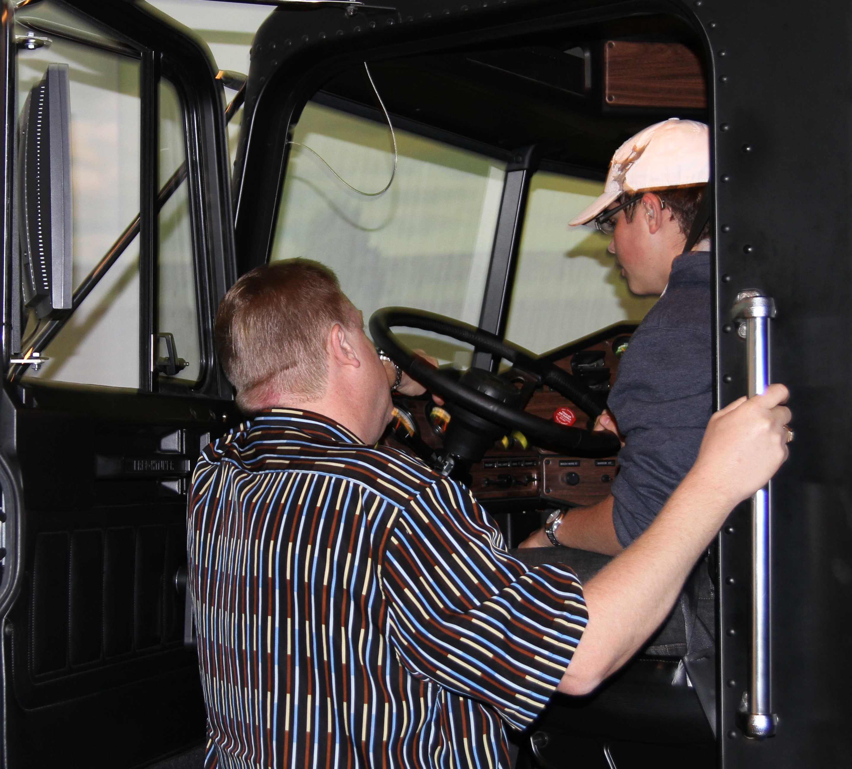 Bison Freightliner tractor on driving on the highway with the SmartWay logo beside it