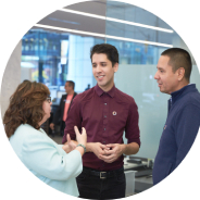 Three employees standing having conversation