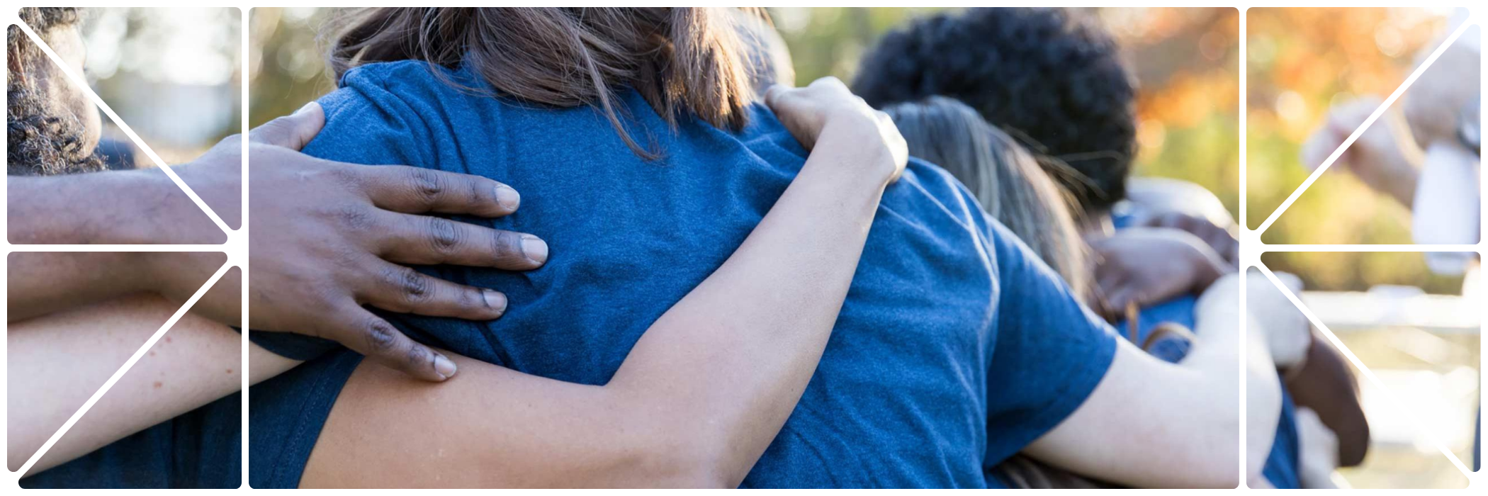 Group of people embracing in a hug type huddle in navy blue tshirts