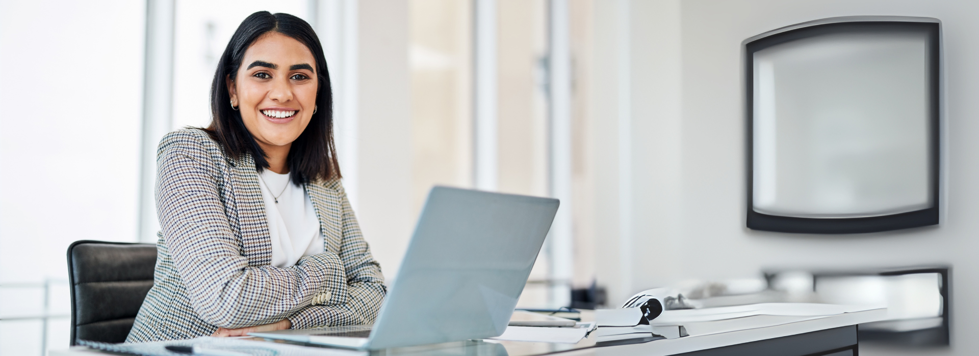 Young professional woman with a laptop in an office