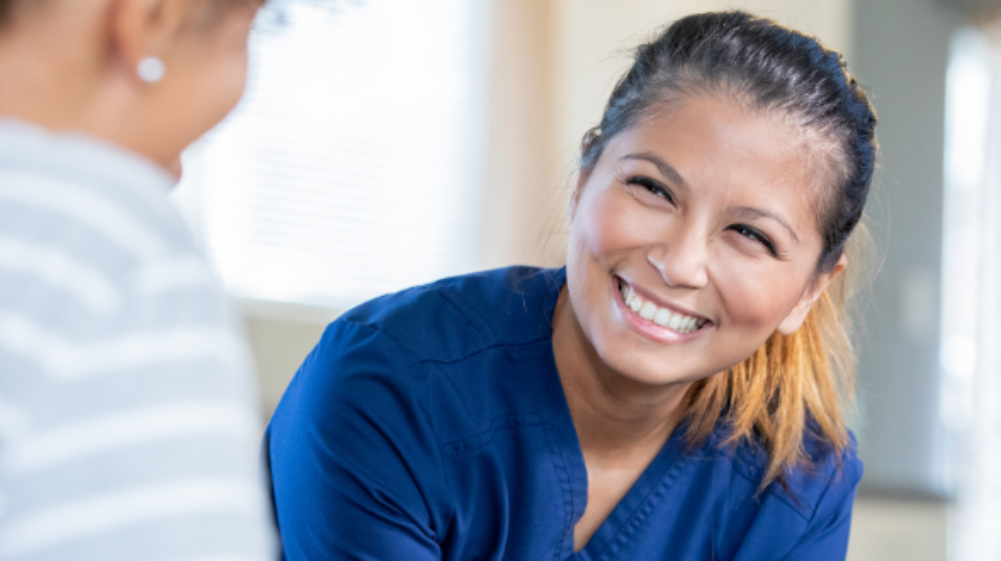 Nurse smiling with patient