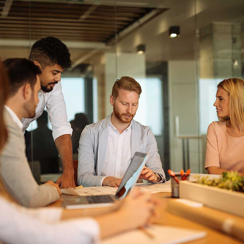 A BluePearl Associate smiles while sitting behind a desk.