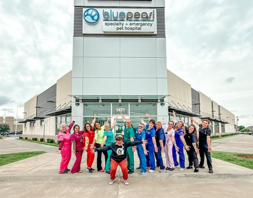 BluePearl veterinary professionals in colorful scrubs stand outside the Oklahoma City hospital.