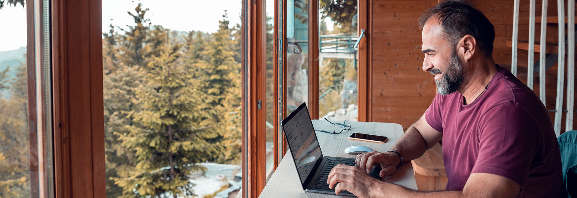 mid-adult-man-using-laptop-in-cabin