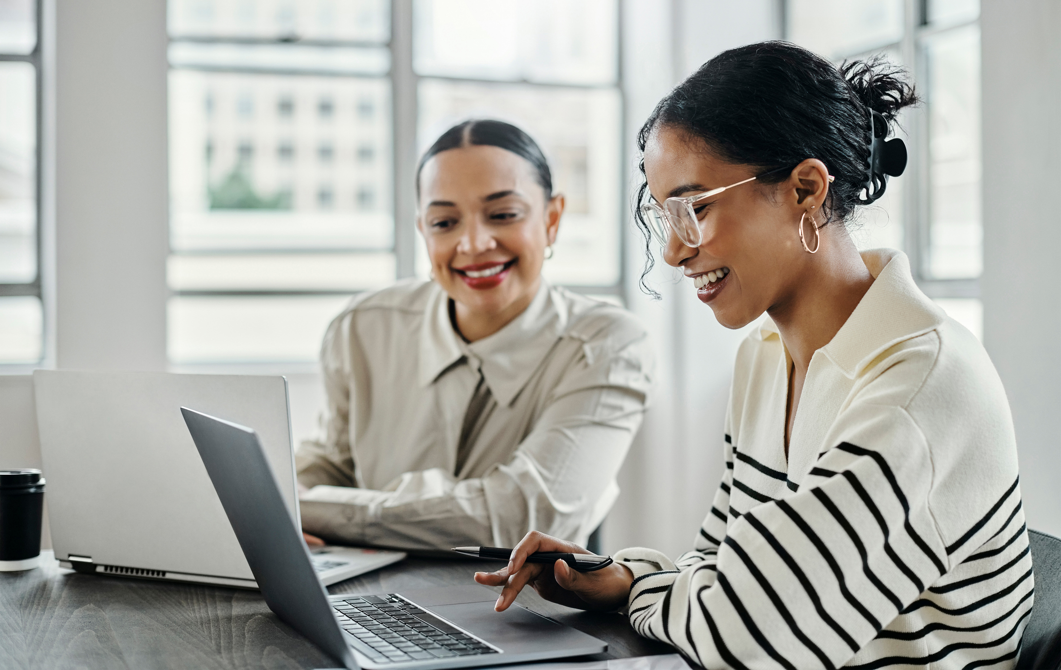 two-young-women-in-office-collaborating