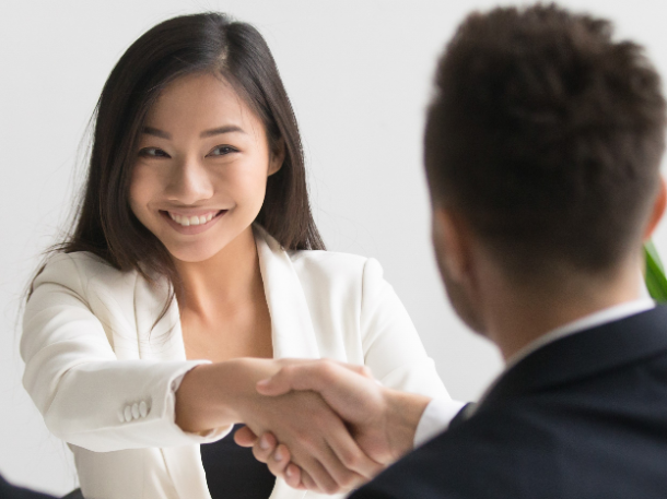 professional woman shaking hands with man