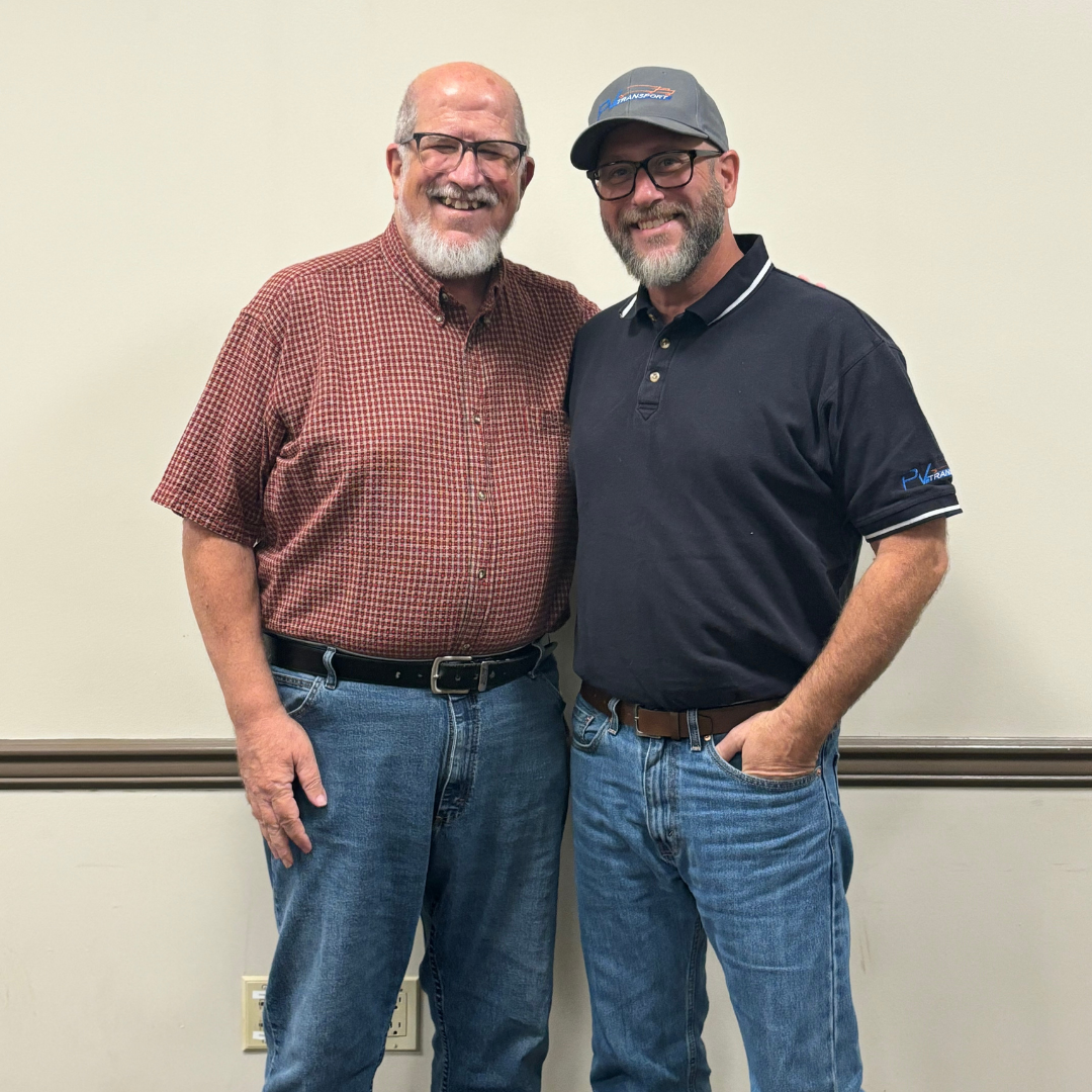 Frank Bucher Sr. and Frank Bucher III smile for a photo together.