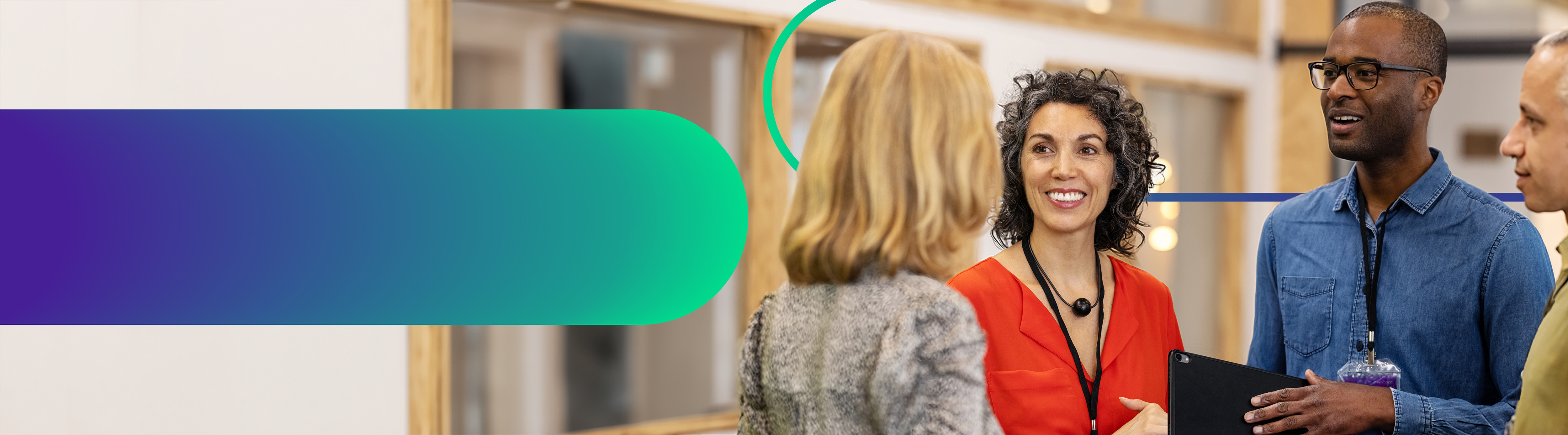 A group of multiracial businesspeople standing in an open office space having a friendly conversation.  