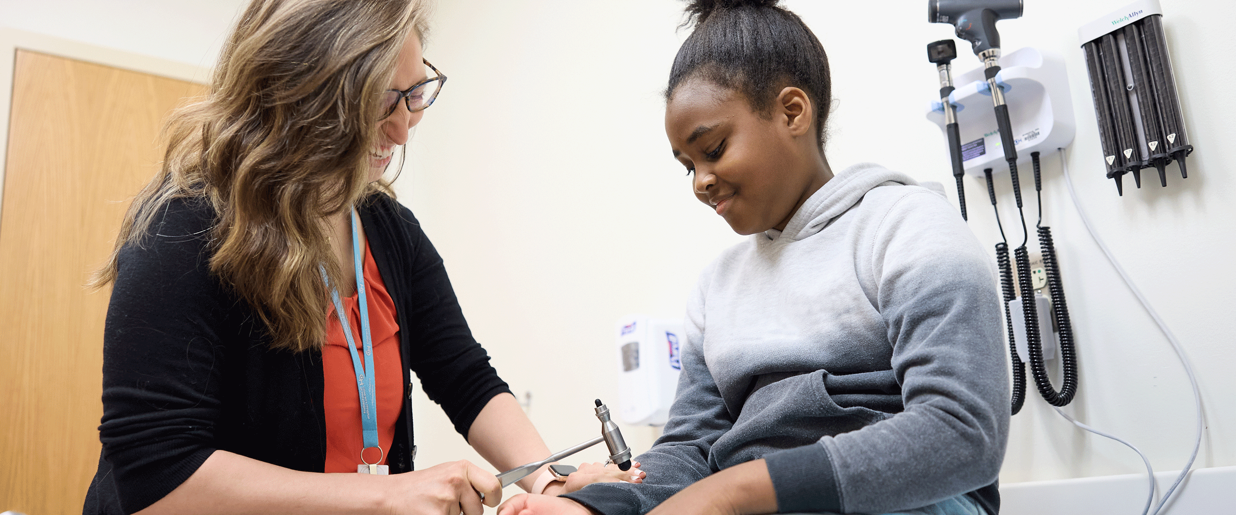 CHOP provider performing a test on patient in exam room