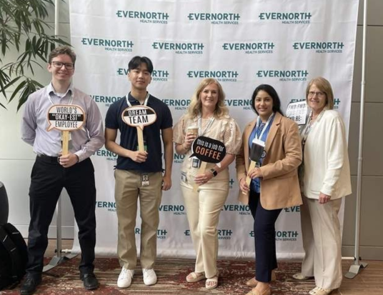 PUDP associates posing with signs at a team event